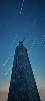 Low angle view of building against blue sky at night