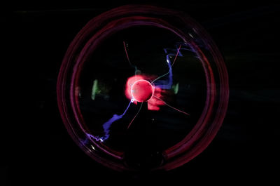 Close-up of illuminated light against black background