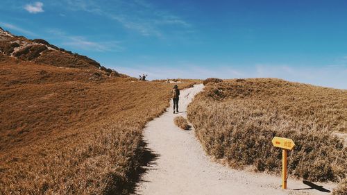 Panoramic view of road amidst landscape against sky