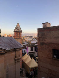 Buildings in town against clear sky