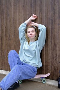 Portrait of young woman sitting on chair