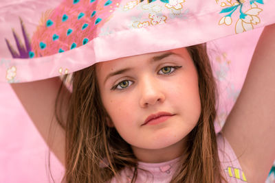 Close-up portrait of girl with pink scarf