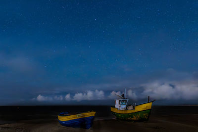 Fishing boats on the baltic sea beach at night