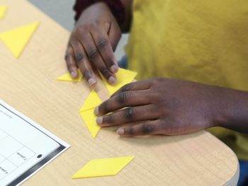 High angle view of woman using mobile phone on table