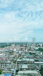 Cityscape against cloudy sky