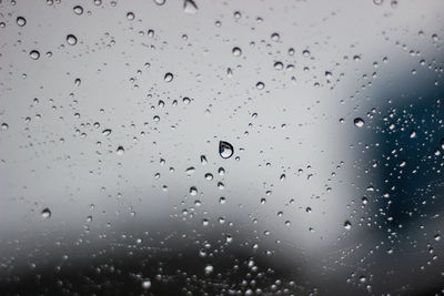 Full frame shot of wet glass window in rainy season