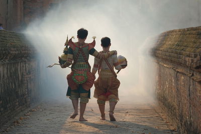 Rear view of people walking on water