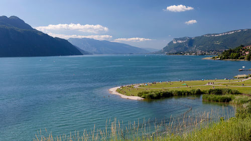 Scenic view of sea and mountains against sky