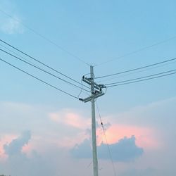 Low angle view of electricity pylon against sky