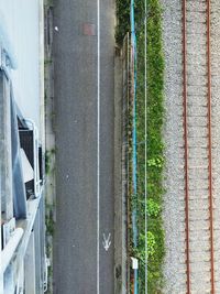 Directly above shot of road amidst building and railroad track