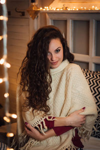 Portrait of smiling woman sitting at home