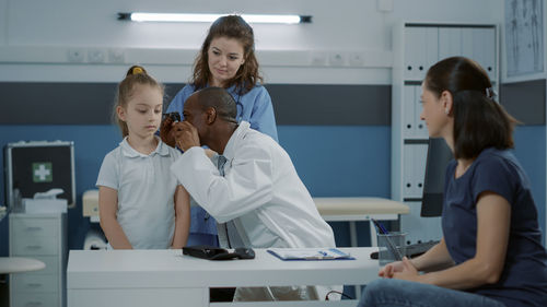 Doctor examining patients ear