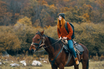 Young woman riding horse