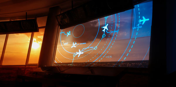 Illuminated text on glass window at night