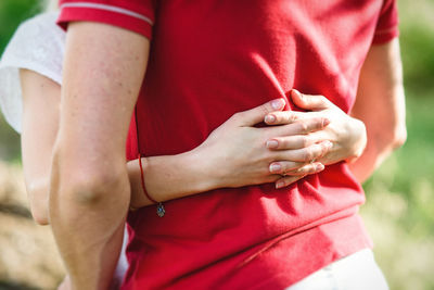 Midsection of man holding hands