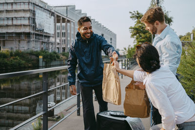 Side view of couple standing in city