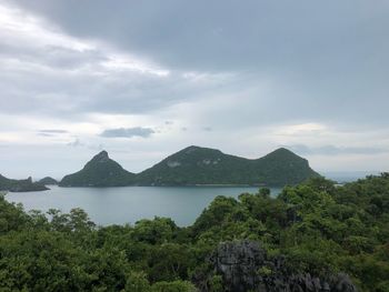 Scenic view of sea and mountains against sky