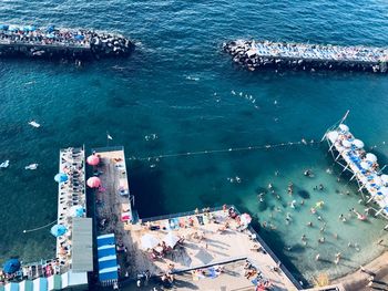 High angle view of crowd by sea at city