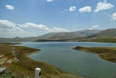 Scenic view of lake and mountains against sky