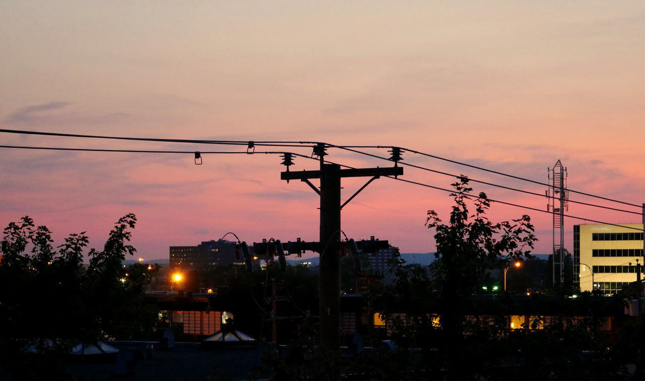 SILHOUETTE BUILDINGS AGAINST SKY DURING SUNSET IN CITY