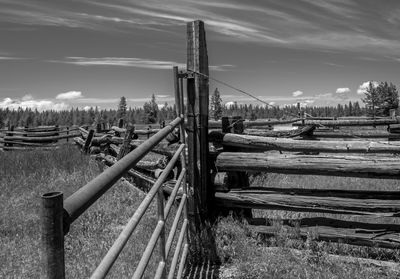 Fence on field against sky