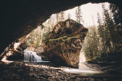 Scenic view of rock formation and waterfall