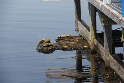 Wooden posts on pier over lake