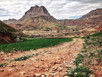 Scenic view of mountains against cloudy sky