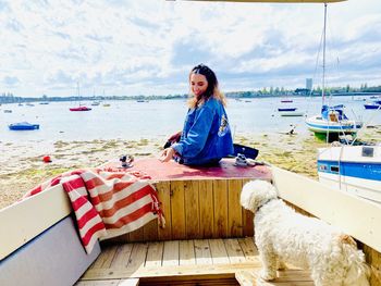 Portrait of young woman sitting at beach