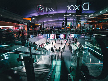 High angle view of people in illuminated city at night