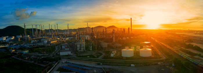 High angle view of illuminated cityscape against sky during sunset