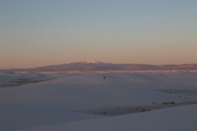 Scenic view of landscape against clear sky during sunset