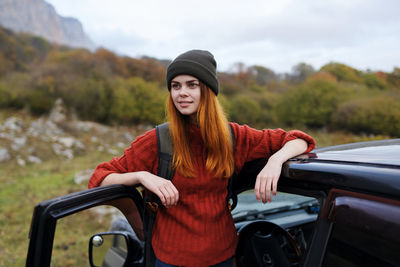 Portrait of young woman in car