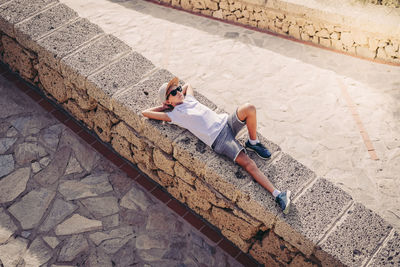 High angle view of woman sitting on staircase