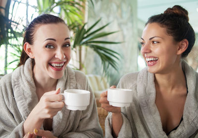 Smiling female friends having coffee