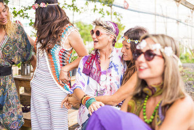 Friends wearing sunglasses and tiaras enjoying in party at park