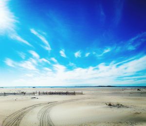 Scenic view of beach against cloudy sky