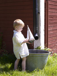 Boy with sailing boat toy