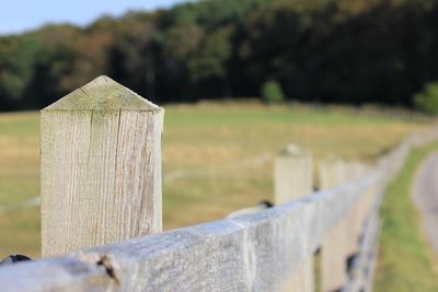 Close-up of wooden fence on field