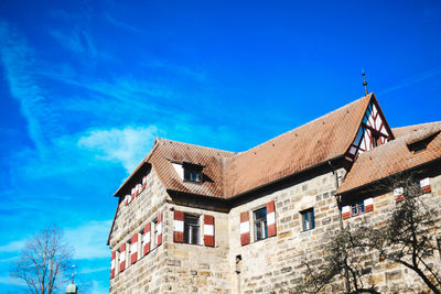 Low angle view of old building against blue sky