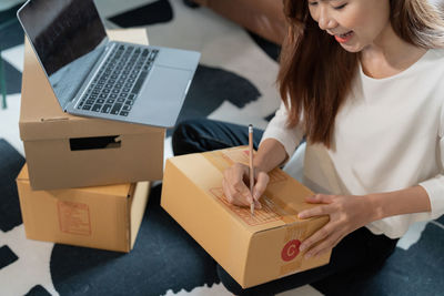 Midsection of woman using laptop