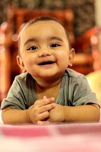 Portrait of cute baby boy sitting on table