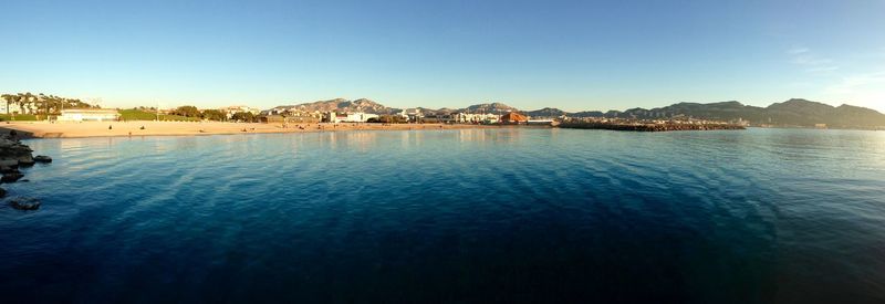 Scenic view of sea against clear blue sky