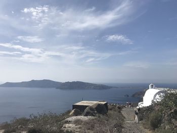 Scenic view of sea by buildings against sky