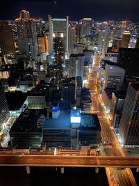 High angle view of illuminated buildings in city at night