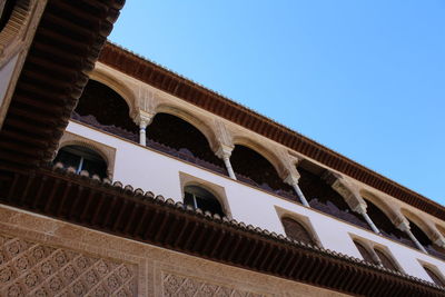 Low angle view of historical building against clear blue sky