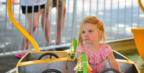 Portrait of young woman sitting on slide