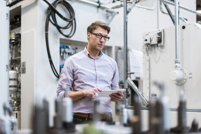 Businessman in factory holding tablet