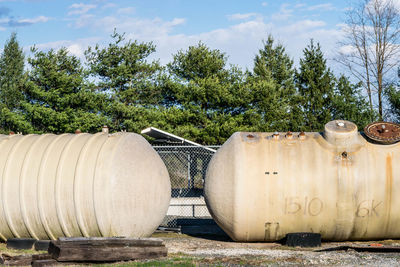 Two large water pipes against trees