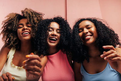 Portrait of smiling friends enjoying at home